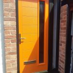 Orange front door installed in Formby